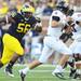 Michigan defensive tackle Ondre Pipkins runs down UMass quarterback Mike Wegzyn in the third quarter at Michigan Stadium on Saturday. Melanie Maxwell I AnnArbor.com